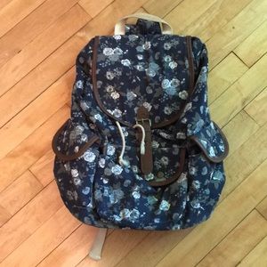 Navy Floral snap backpack with leather details